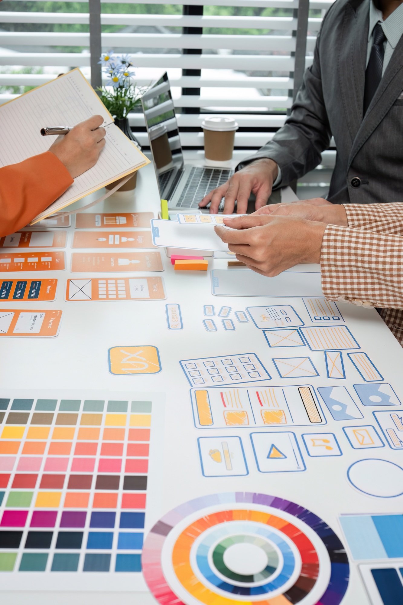 Creative Team Collaborates on UX UI Design Project with Color Palettes and Wireframes in Modern