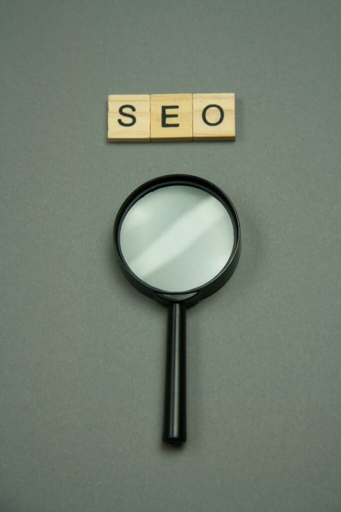 SEO written in wooden letters and magnifying glass.